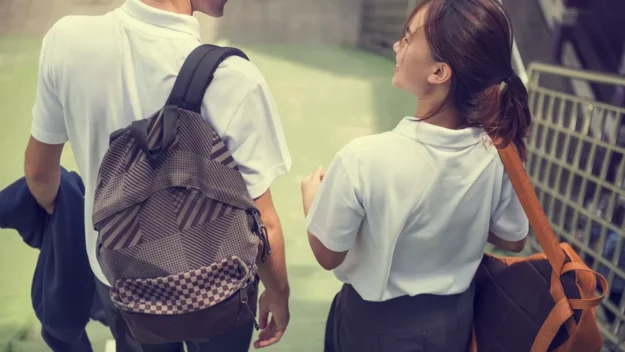 Young People Walking To School Together
